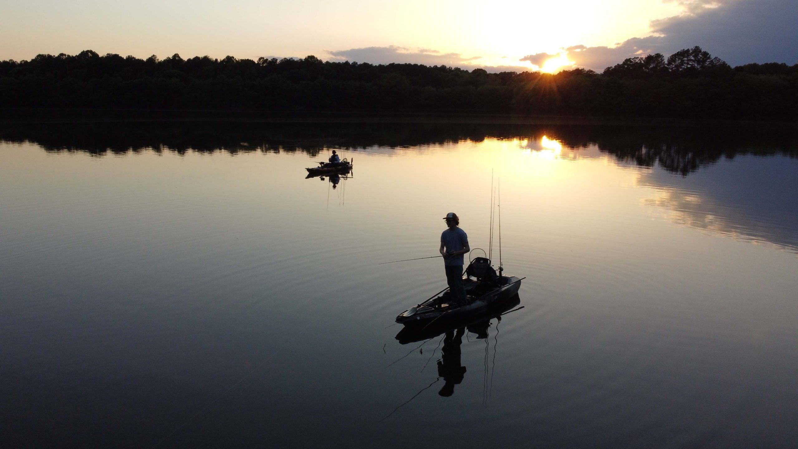 Drone shot of kayak fisherman with sunset